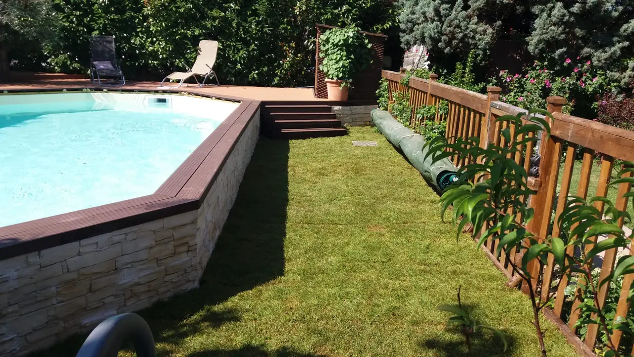 Pelouse neuve posée en plaques autour d’une piscine.